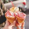 three colorful tasty ice cream cones in hands 